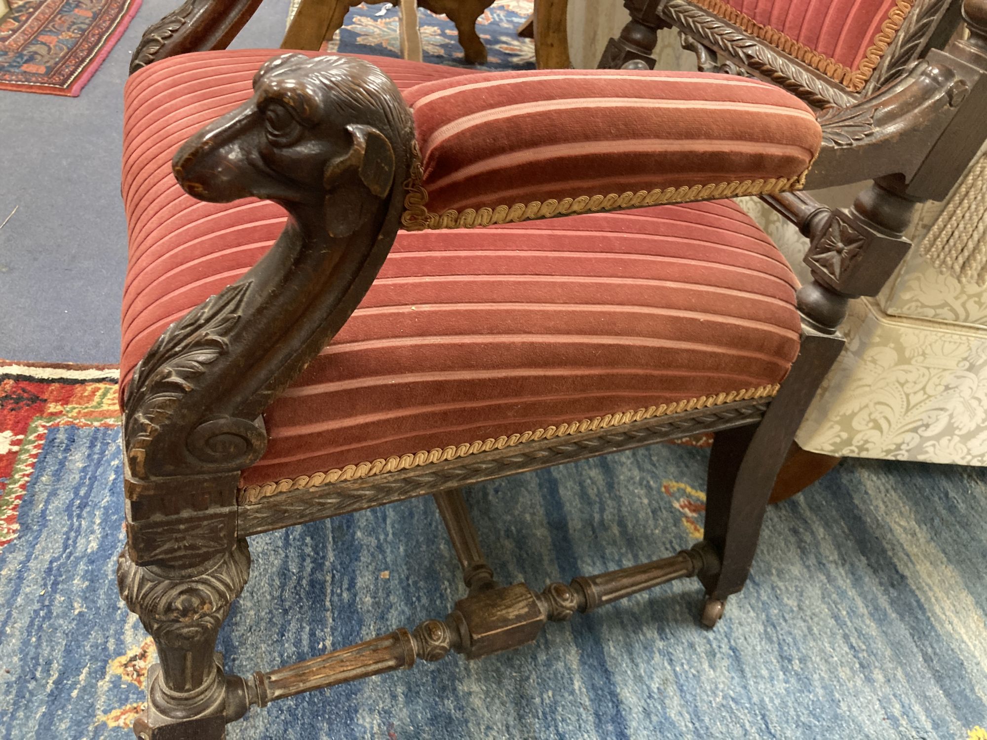 A late 19th century oak Carolean style armchair, with carved dogs head arms, width 68cm, depth 66cm, height 130cm